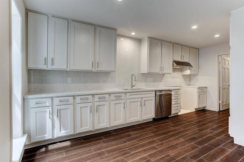 Kitchen has been updated with quartz counter-top and backsplash, large stainless sink & faucet, and 36" gas range and convection oven (not shown), Whirlpool refrigerator and recessed LED lighting.
