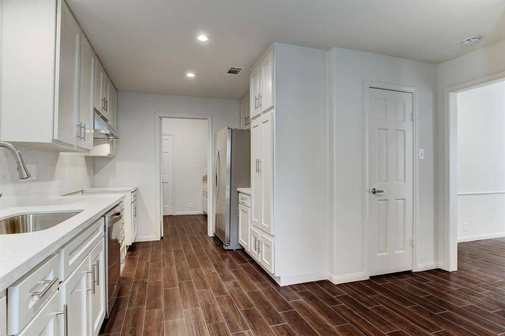 Kitchen features generous sized pantry and cabinets and opens to the utility and mud room with additional storage closet, two large felt lined cabinets for silver storage and a separate cabinet with sink.