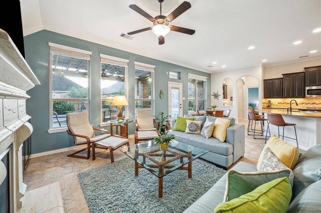 Natural light flows in from floor-to-ceiling windows in the living areas
