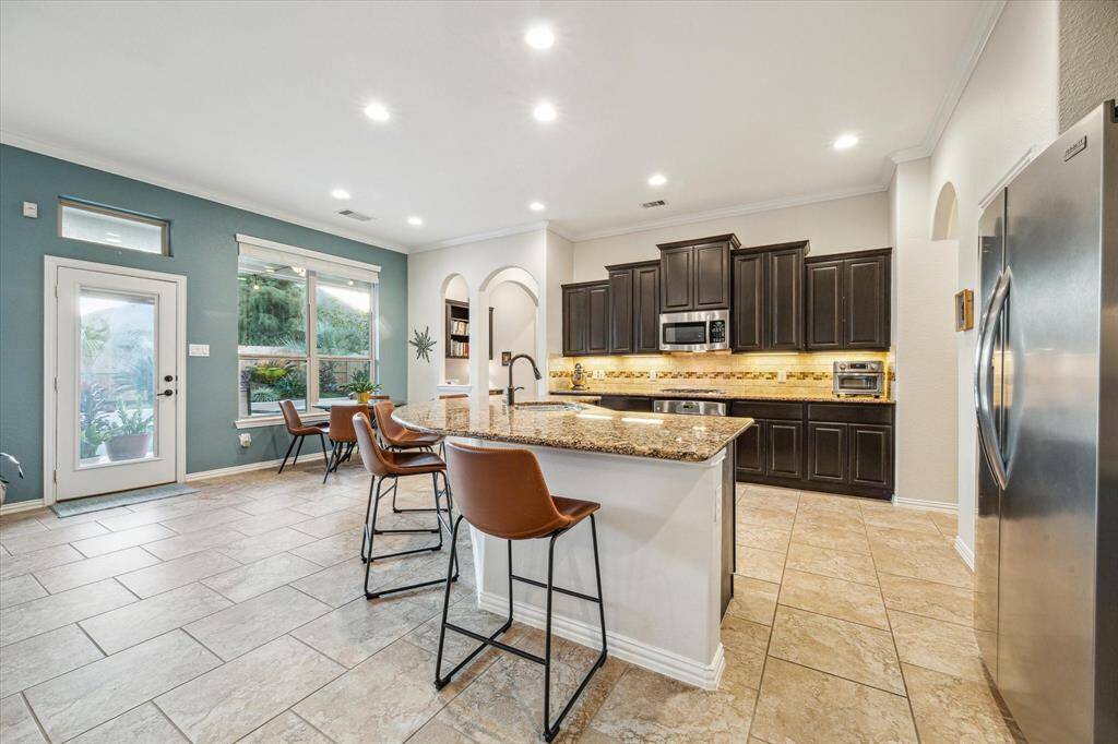 Stainless steel appliances with gas cooktop.