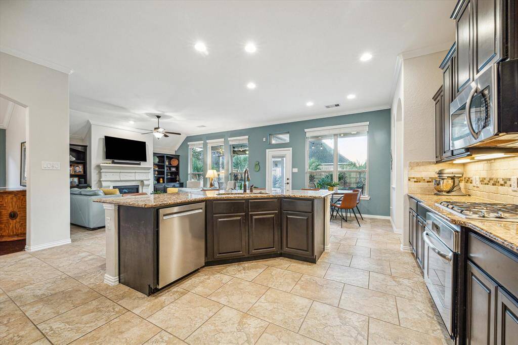 Kitchen has large island that opens to living area