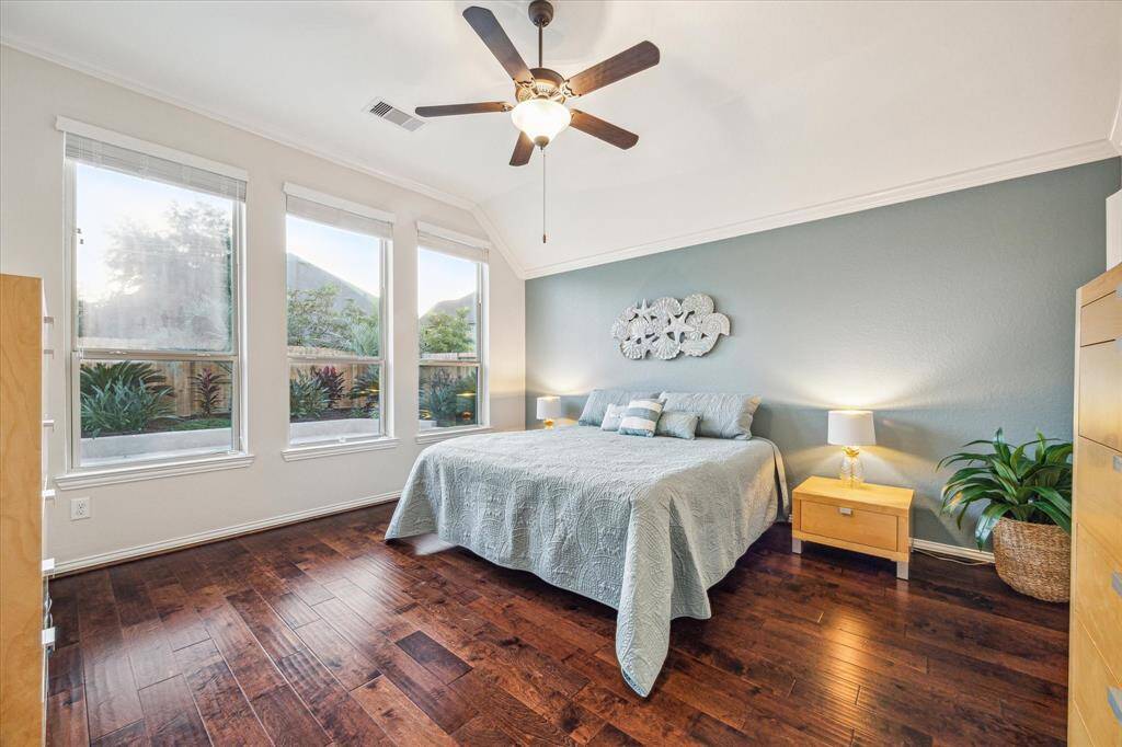 Large primary bedroom with windows looking out to pool
