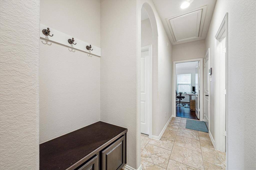 Coat and shoe storage nook as you walk in from garage