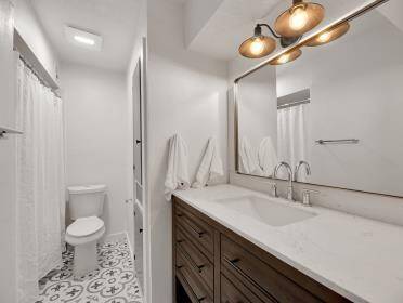 Upstairs bathroom with long counter space.