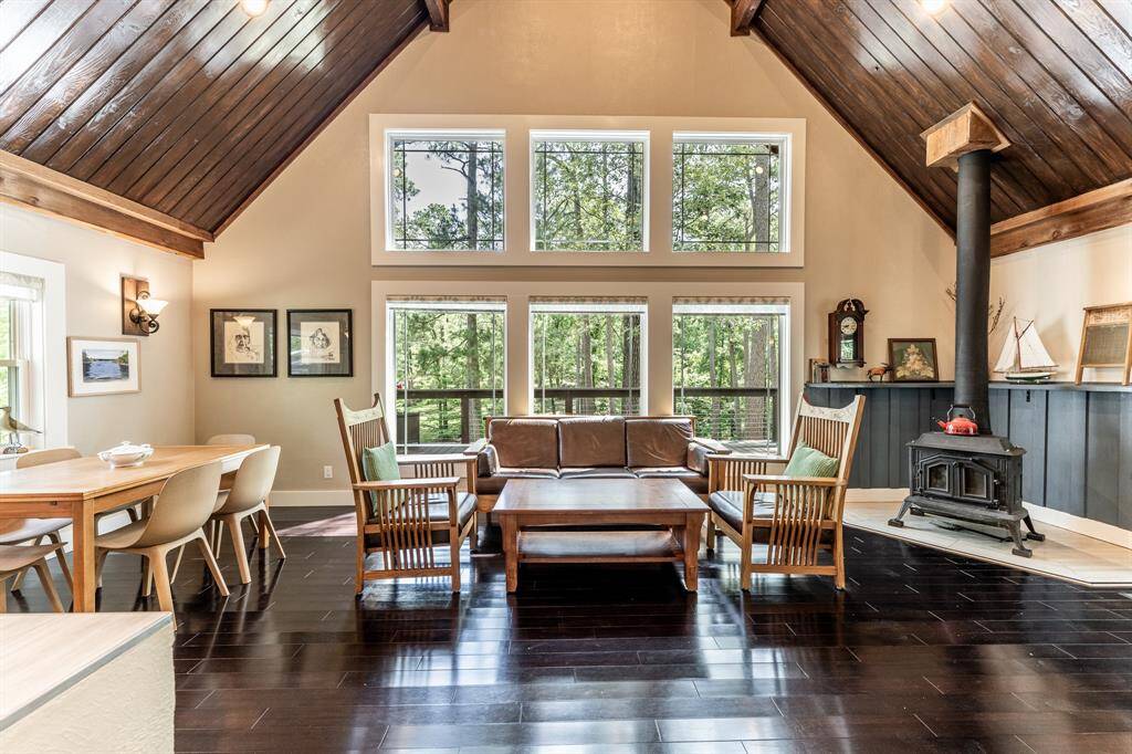 Beautiful wall of windows features updated Wincore windows with Prairie perimeter grid and custom designed window shades. All windows in the house were replaced and all but the top 3 in the living room feature the custom shades.