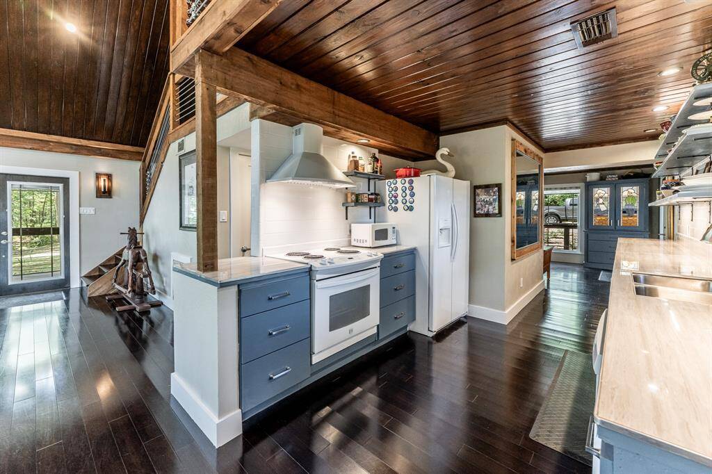 Fully updated galley kitchen.  30 inch drop in range and side by side refrigerator with water and ice in the door.  Refrigerator will remain.