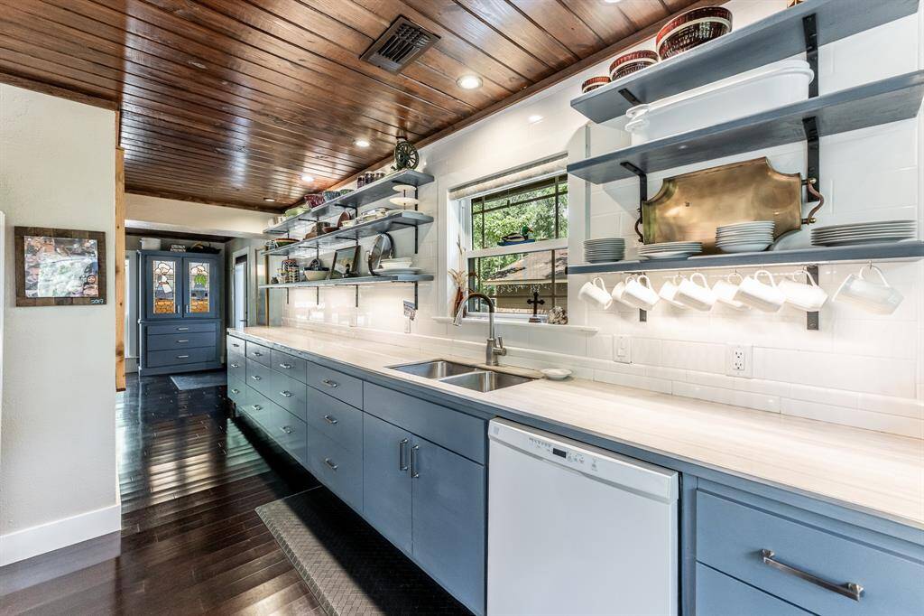 Tons of drawers on the bottom for all the kitchen essentials, and all upper cabinetry is open allowing the perfect place to display all your beautiful kitchen dishes. Hand scraped strand woven bamboo flooring in warm espresso is found throughout the house, and the ceiling throughout most of the house is done with custom planks.