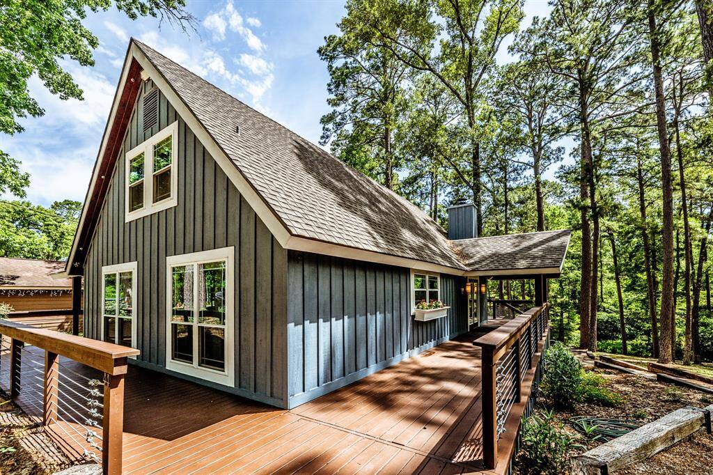 2 story A-Frame house with an 1135 sqft wrap around porch on 3 sides and cedar siding. Porch features entry ramp, 2 sets of stairs, and cable sides. Recent roof and all windows replaced.