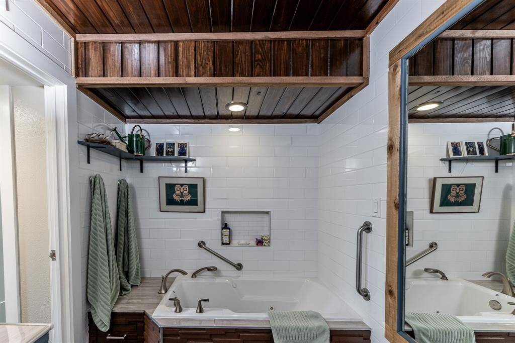 Downstairs bathroom has a deep MTI soaking/jetted tub with shower attachment and a Kohler toilet.