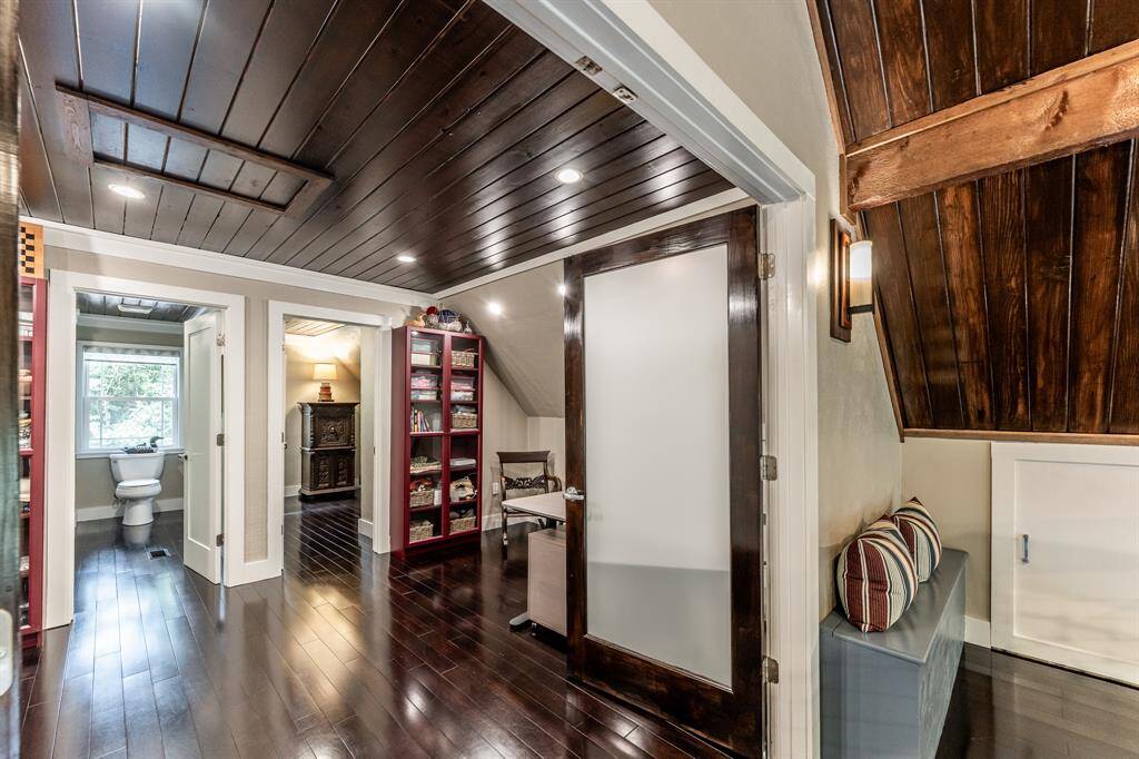 A tour of the upstairs.  When you come up the stairs, you will be met with the frosted double doors and the nook area.  The blue bench on the right side of the photo is the nook area.  This picture show the doors open, and you can see the front room, the bathroom (left door) and the bedroom (right door).