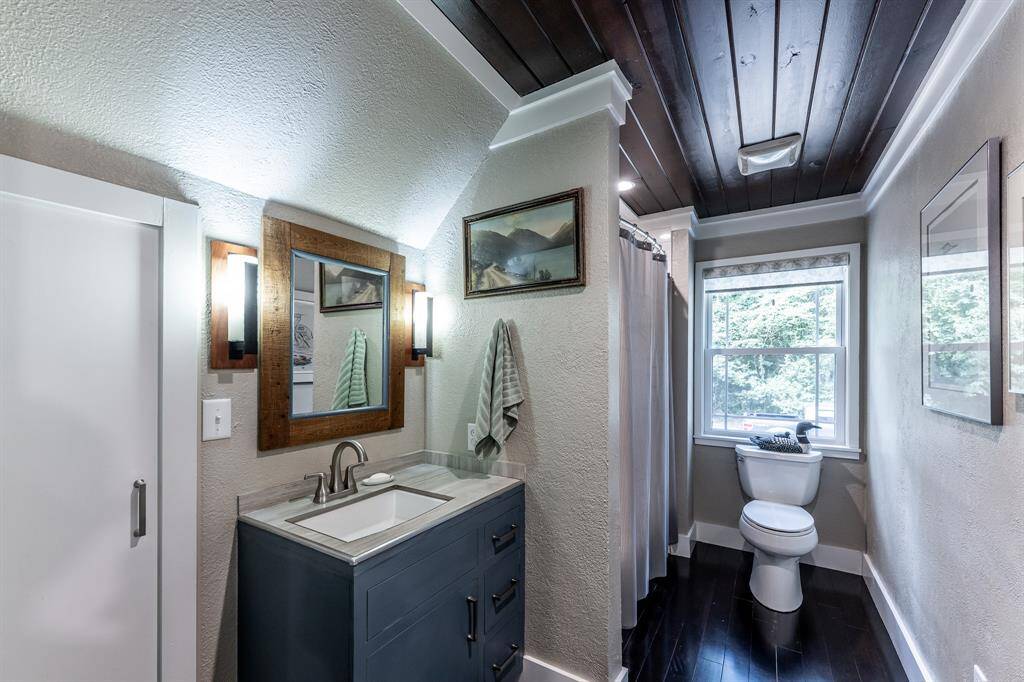 Upstairs bathroom has a Kohler Tub/Shower Combo and a Kohler toilet.  Sink has a Moen faucet.  Door to the left of the photo takes you into the upstairs attic storage area.