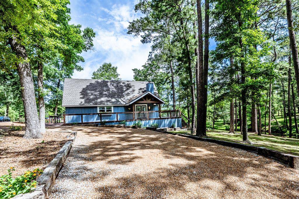 The circular driveway with a flower/tree bed on the left.