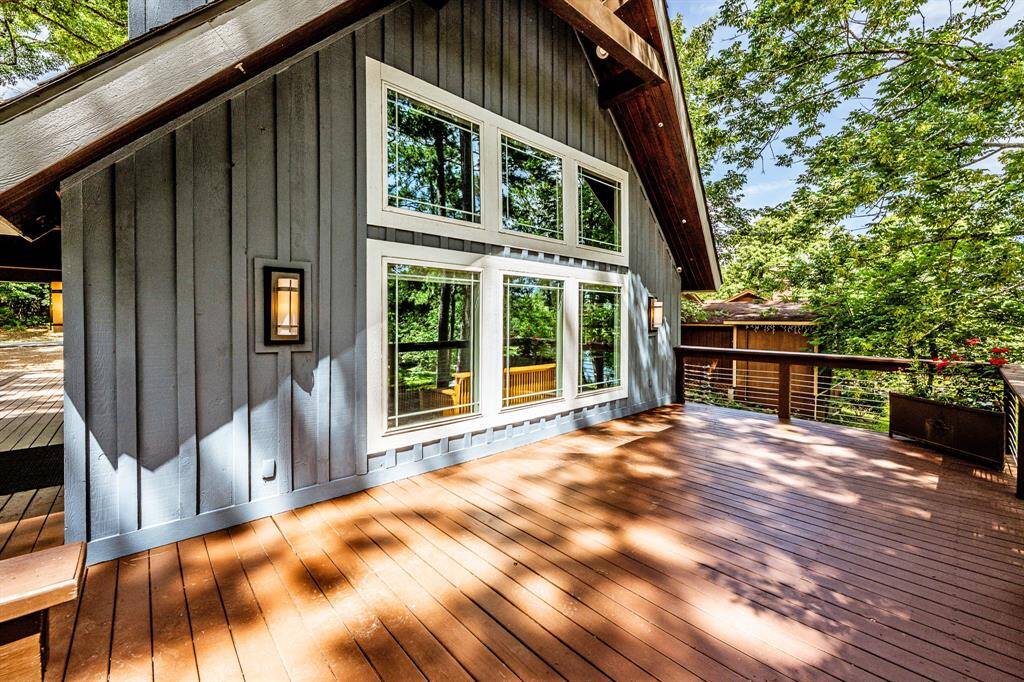 The large deck off the back of the house.  The windows you see here are the same windows you see in the living room of the house.  On the eaves, you will see some nozzles.  These nozzles are attached to a Spider-B-Gone perimeter spray system to help with mosquitos and other outside insects.