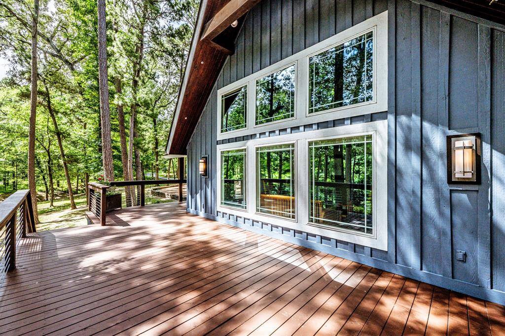 Looking from the deck out to the partially wooded side yard.