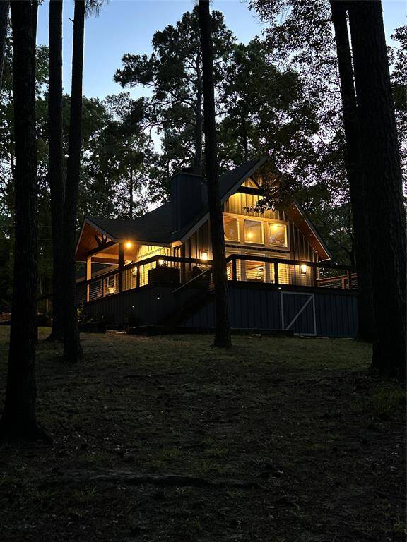 With all the interior lights on, the house is beautifully perched on the lake at night.