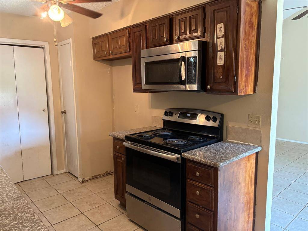 Kitchen has microwave and stainless range
