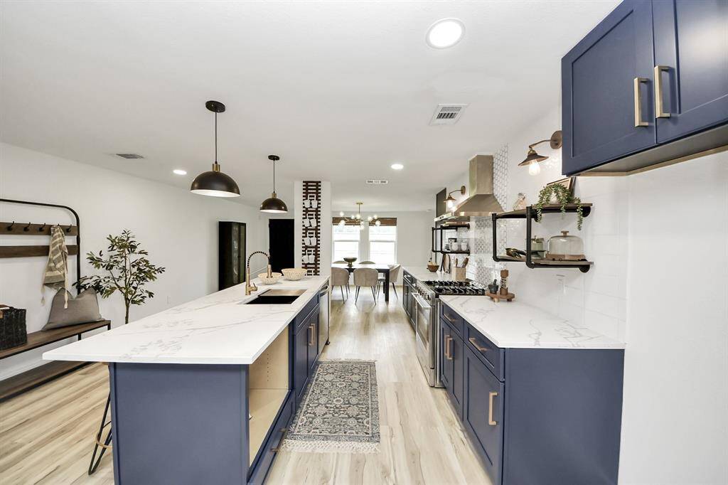 The kitchen features custom cabinets,creating a clean and timelessaesthetic.