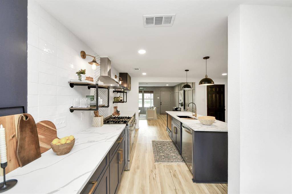 The kitchen has plenty of counter space and beautiful tile backsplash.