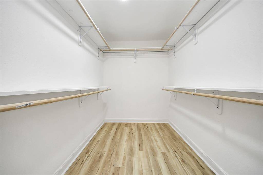The primary walk-in closet features plenty of storage space.