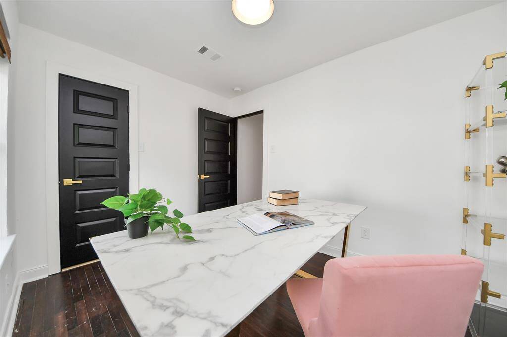 The third bedroom has dark doors with beautiful hardware.
