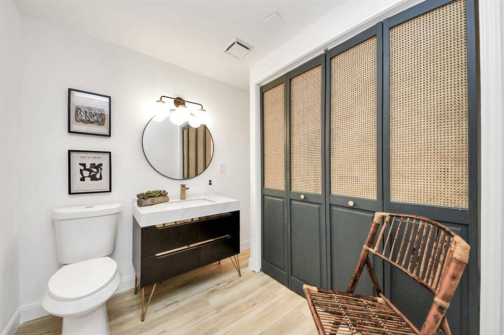 The spacious half bathroom has a beautiful vanity.