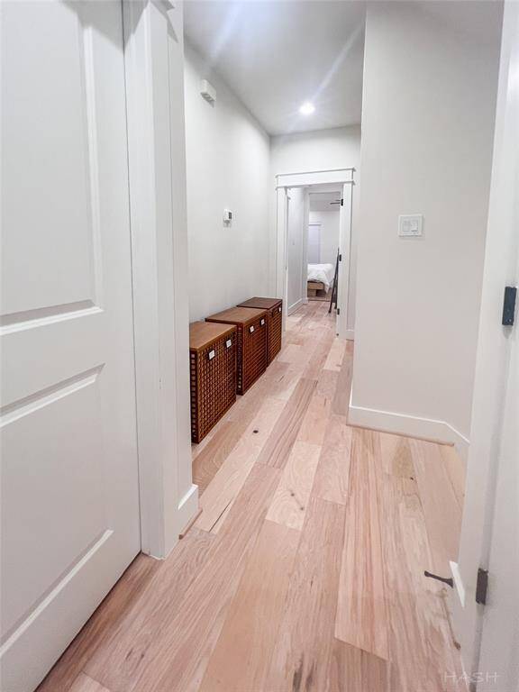 Hallway to all three rooms on the second floor including the primary. The optional 4th bedroom/gameroom is located on the third level and has a private bathroom.