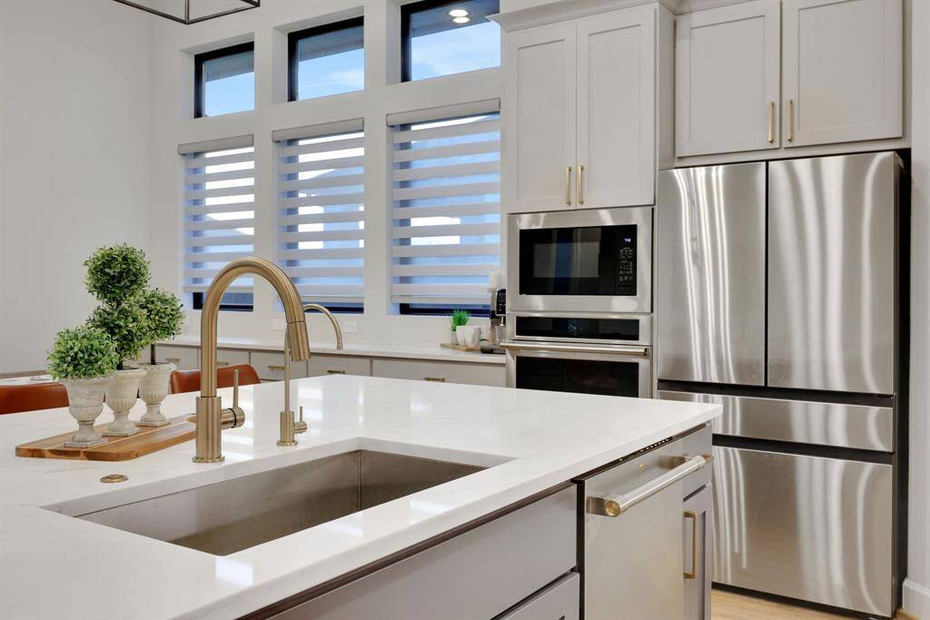 Gorgeous updates include quartz counters and stainless appliances (fridge included!)