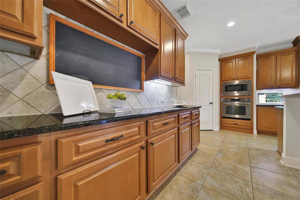 Ample counter and cabinet space doubles as a built-in buffet area, perfect for serving and storage.