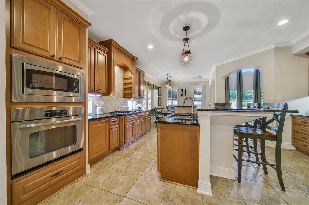The kitchen features sleek GE appliances for modern convenience.