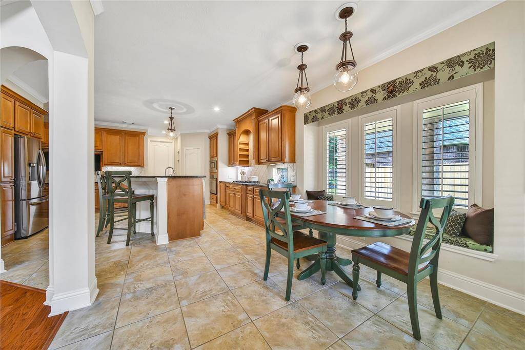 Two designer pendant lights illuminate the breakfast area with a stylish, focused glow.
