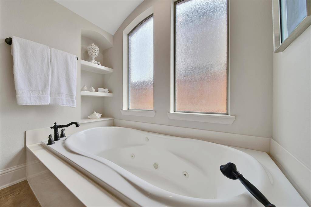 Soothe away all your worries in this jetted tub with roman shower handle.