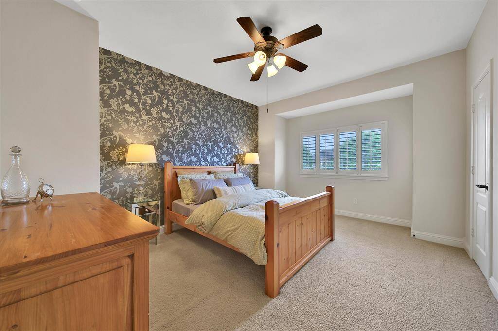 Guest Suite located off the Gameroom has a ceiling fan & walk in closet .