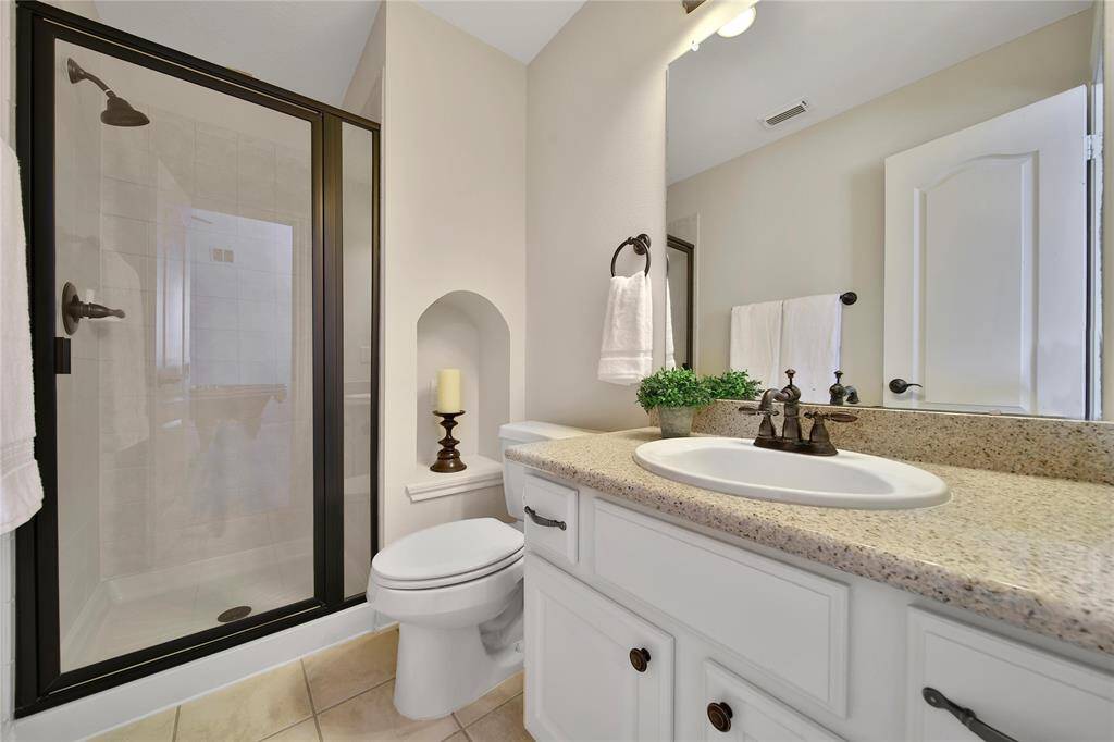 Adjoing bath located in the hallway features a walk in shower.