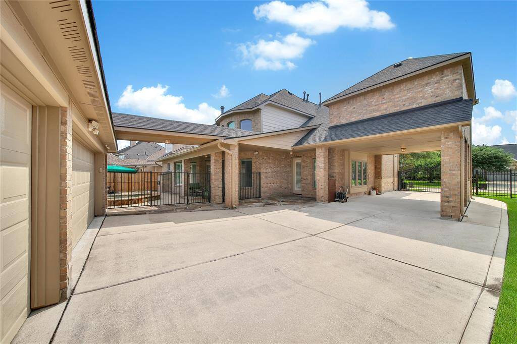 A driveway gate and porte cochere enhance both security and curb appeal while offering convenient, sheltered access to your home. Automatic Gate is controlled through the My Q app!