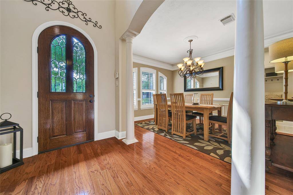 Rich wood floors warm the entry and extend into the dining & living areas.