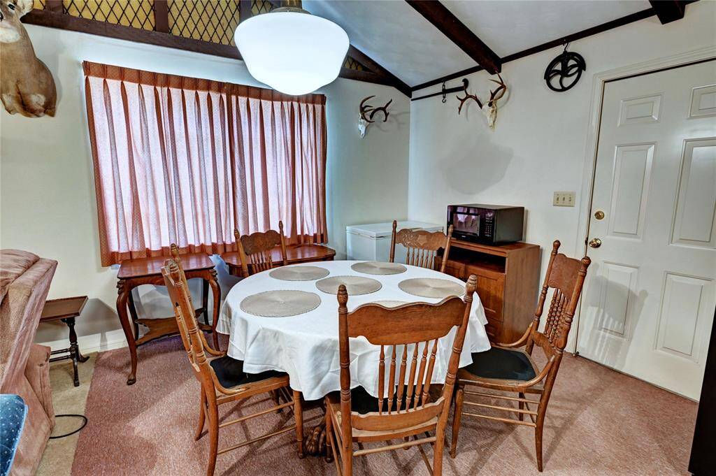 Dining area with backdoor leading to the covered porch