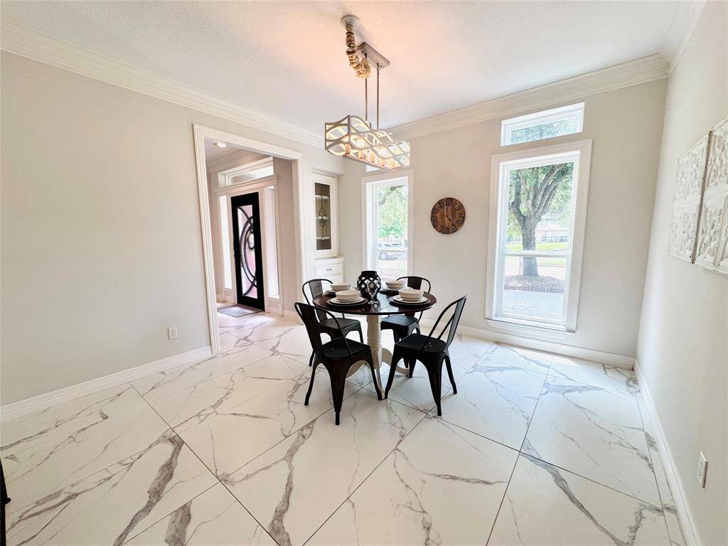 The floor-to-ceiling windows offer ample natural light and golf course views! The room also has a china hutch/cabinet for holding your silverware, linens, etc.