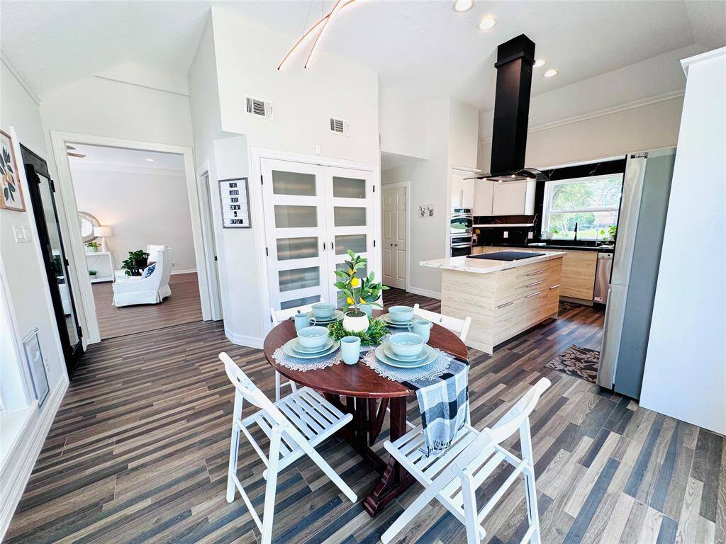 The pantry was expanded to have double doors and a wire/wood storage shelving system! The powder room is just to the left across from the back door!