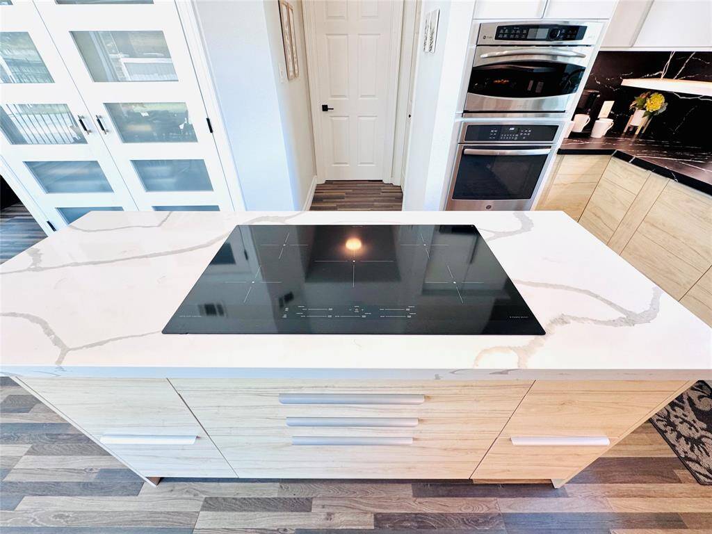 The induction cooktop makes cooking so easy, notice the ample drawer space below that offers plenty of storage!