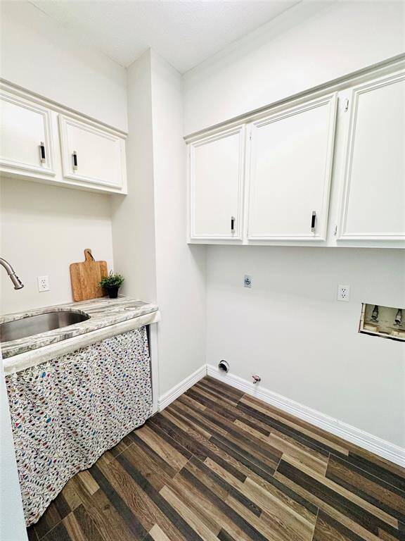 The laundry room received a recent upgrade with repainting the cabinets and adding the sink and counter to this area!