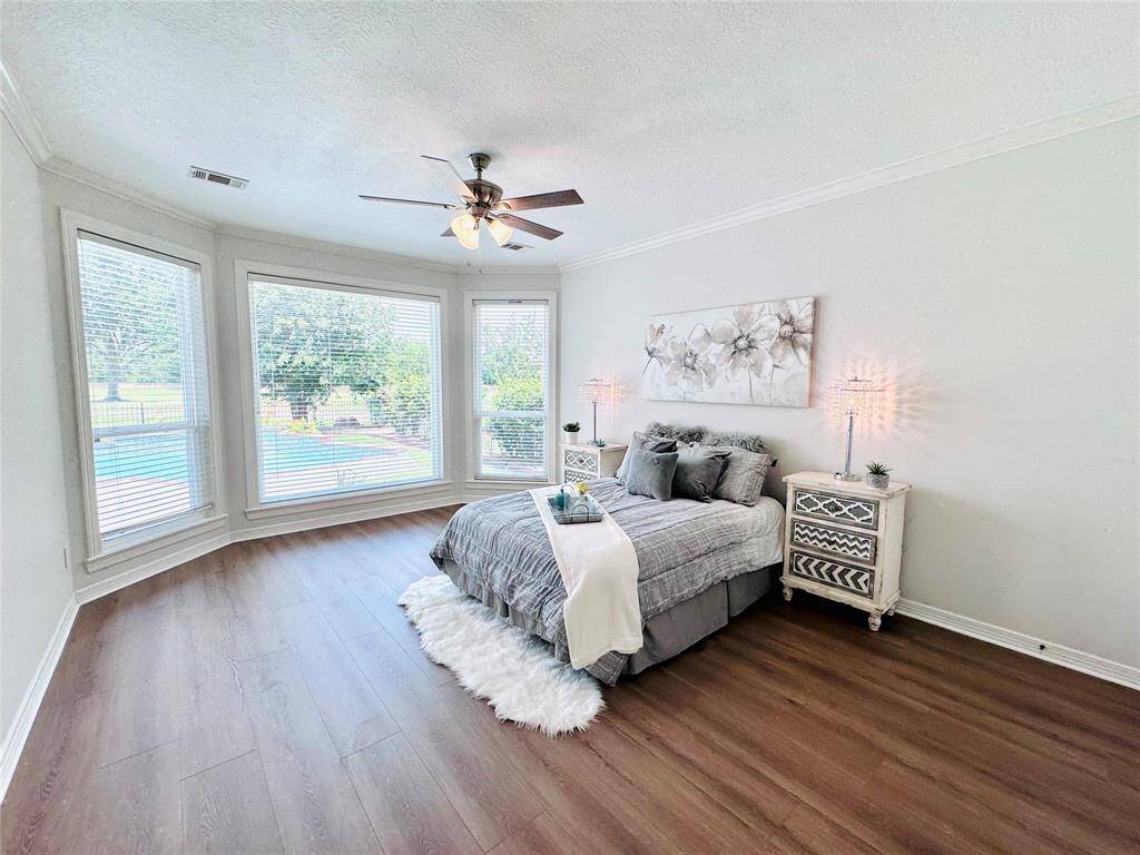 The Owner Bedroom is bright and spacious bedroom with large bay Low E Double Pane windows offering a scenic view of the pool!