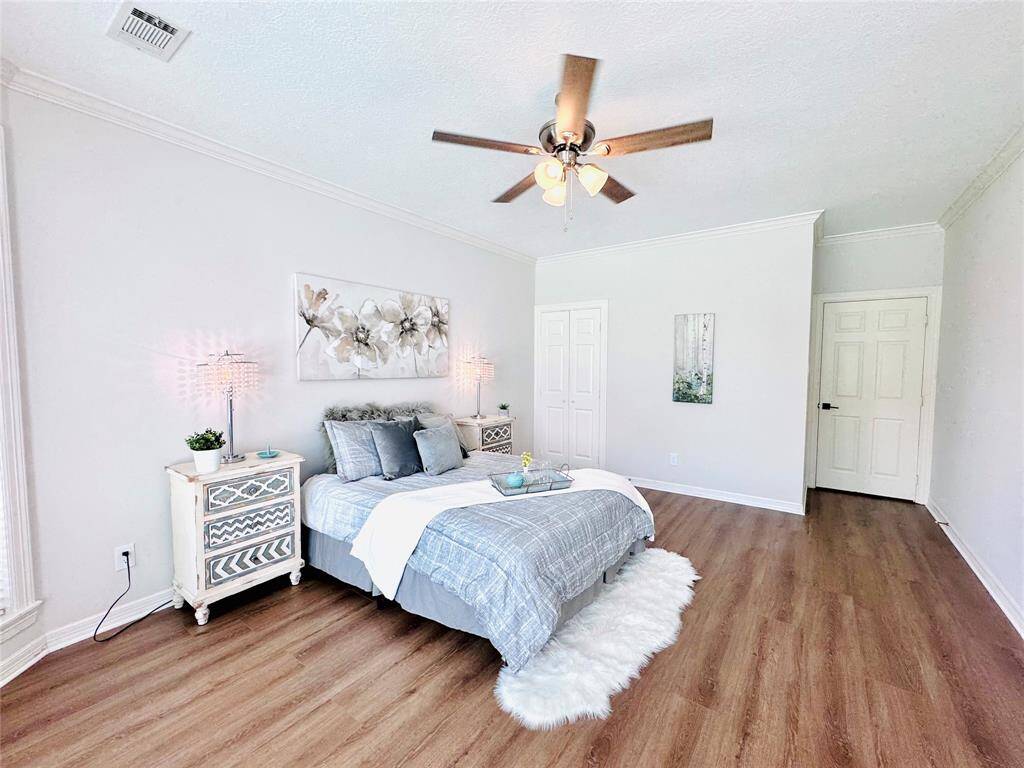 The Owner Suite is perfectly situated at the back of the home to get those beautiful sunrises to start your day! It has newly installed LVP Wood flooring, an updated ceiling fan and paint!