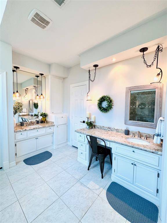 The Owner Bath is so spa-like with a vanity, custom lighting and granite counters, his and her sinks, two walk in closets and a massive walk-in-shower!