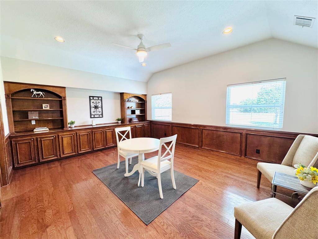 The Game Room features warm wood flooring and elegant wainscoting! It includes built-in bookshelves and cabinets! This space will be perfect to hang out and have fun!