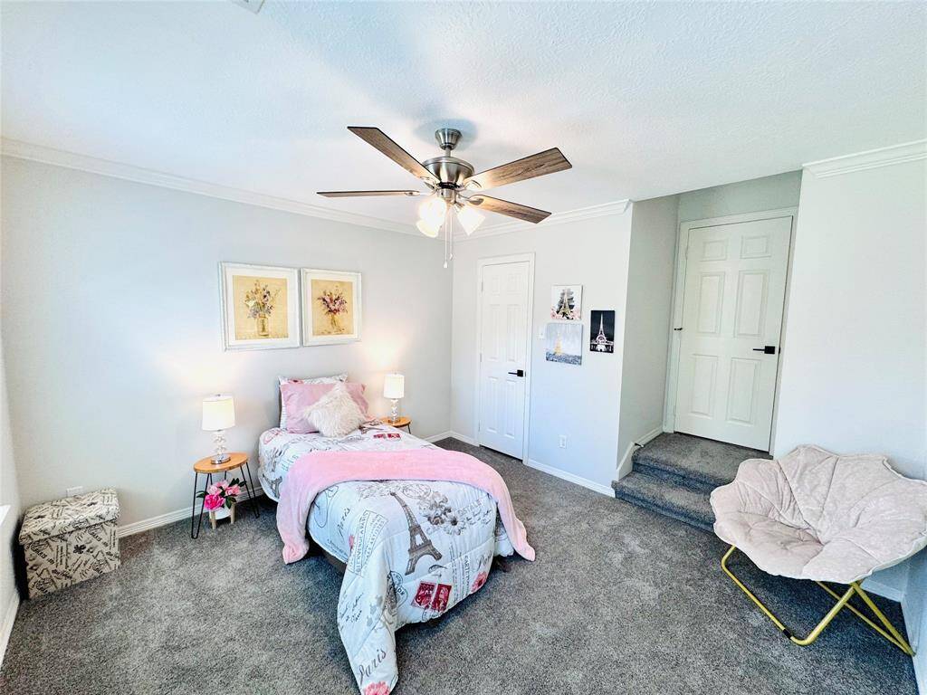 Across the hall, Bedroom Four has updated carpet, ceiling fan, and paint! The steps up lead to Batrhoom #2!