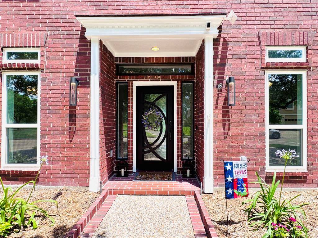 The front and back have custom metal/glass doors that are just stunning! Updated lighting and Low E Hurricane Resistant Windows showcase the strength and beauty of this home! Photo enhanced.