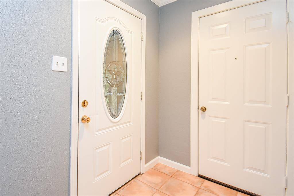 Stylish new entry and garage doors leading to a welcoming patio.