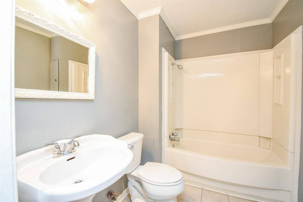 Elegant master bathroom, one of two, featuring modern fixtures and a spacious tub for ultimate relaxation.