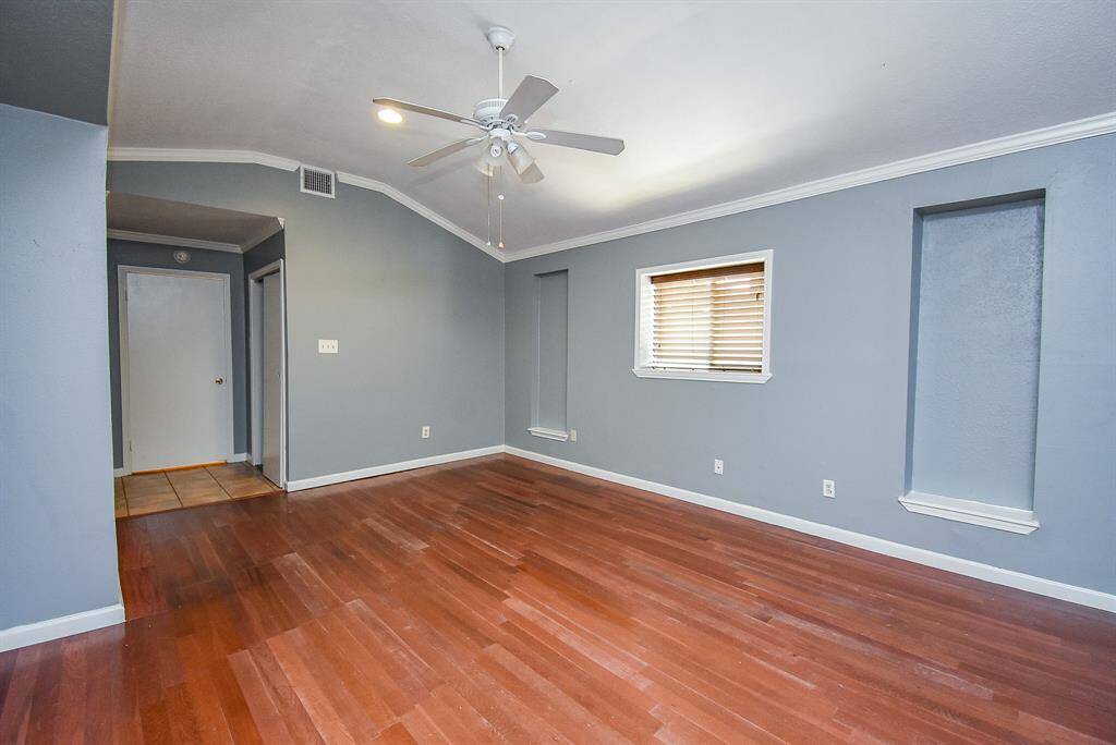 Spacious second master bedroom with elegant hardwood floors and abundant natural light.
