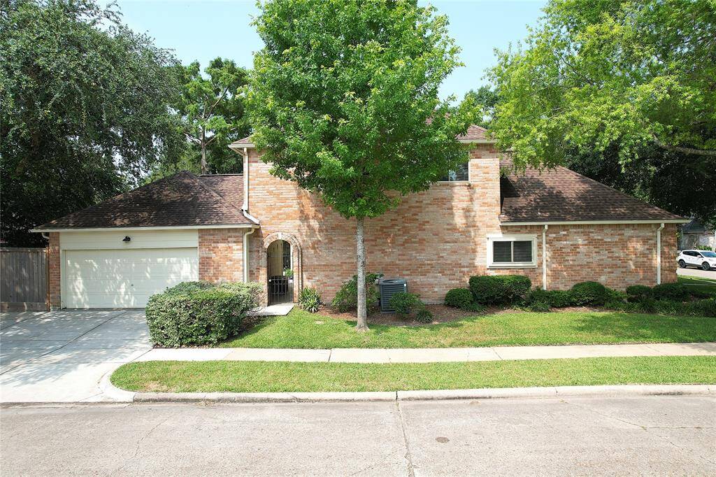 Two-car detached-attached garage with breezway leading to laundry room.